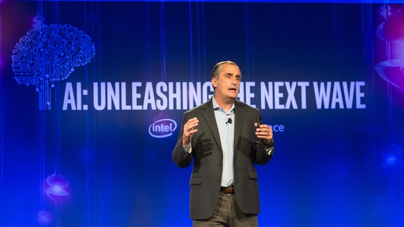 Intel CEO Brian Krzanich on stage with "AI: Unleashing the Next Wave" projected behind.