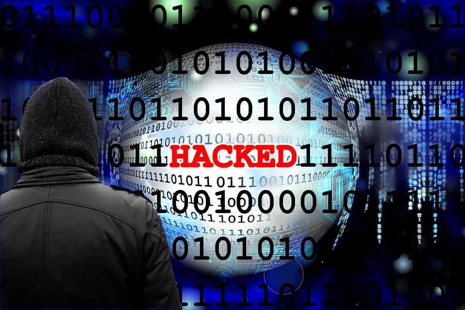 Image showing binary code in background with the word "HACKED" in foreground.