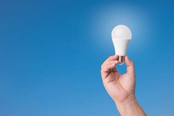 Person holding an LED lightbulb.