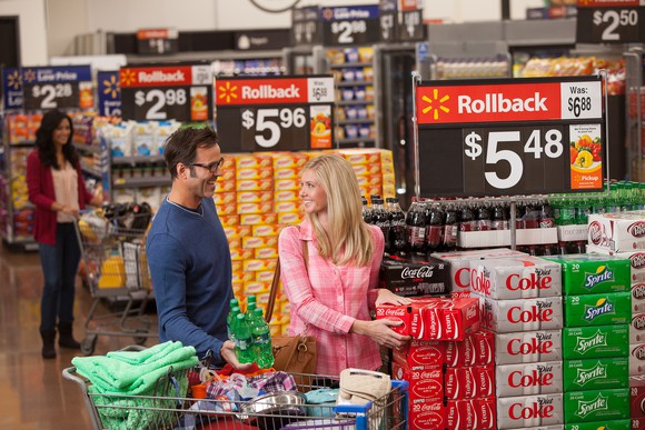 A couple smiles while shopping a "roll back" deal at a Wal-mart store.