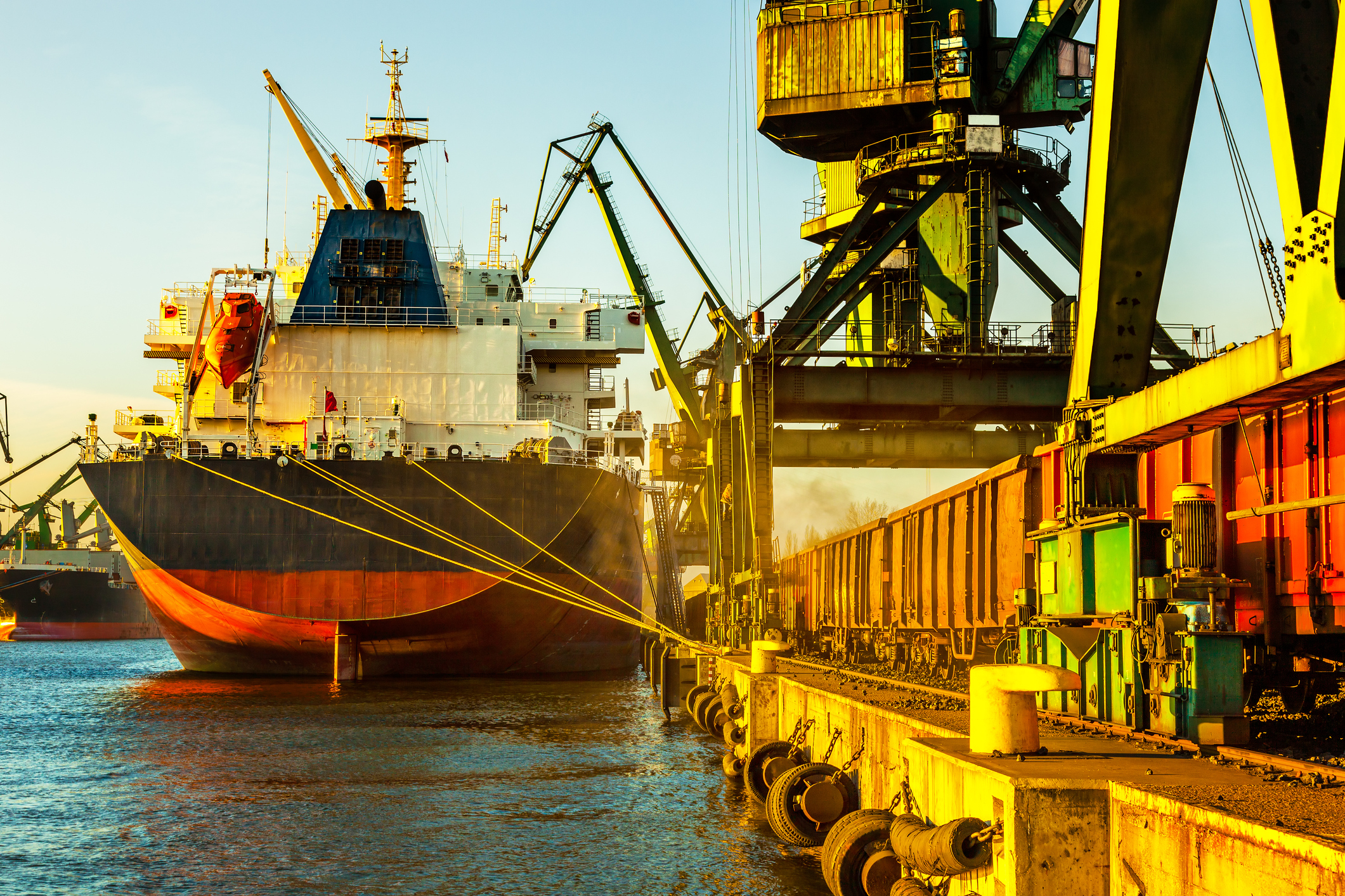 Ship at port getting loaded with cargo.