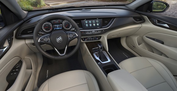 The front seat and dash of a new Buick Regal are shown.