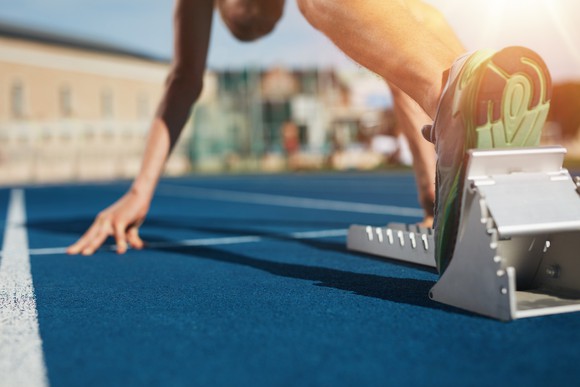 A sprinter getting into the starting blocks.