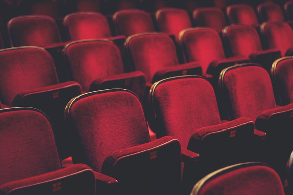 Empty comfortable red seats with numbers in cinema