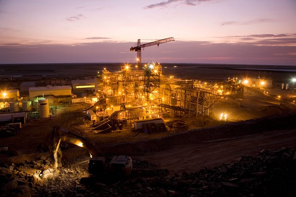A view of the Tasiast mine, illuminated against a dimly lit sky.