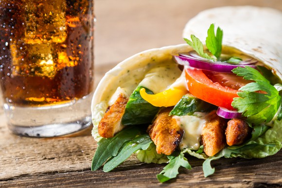 Image of a chicken wrap and soft beverage.