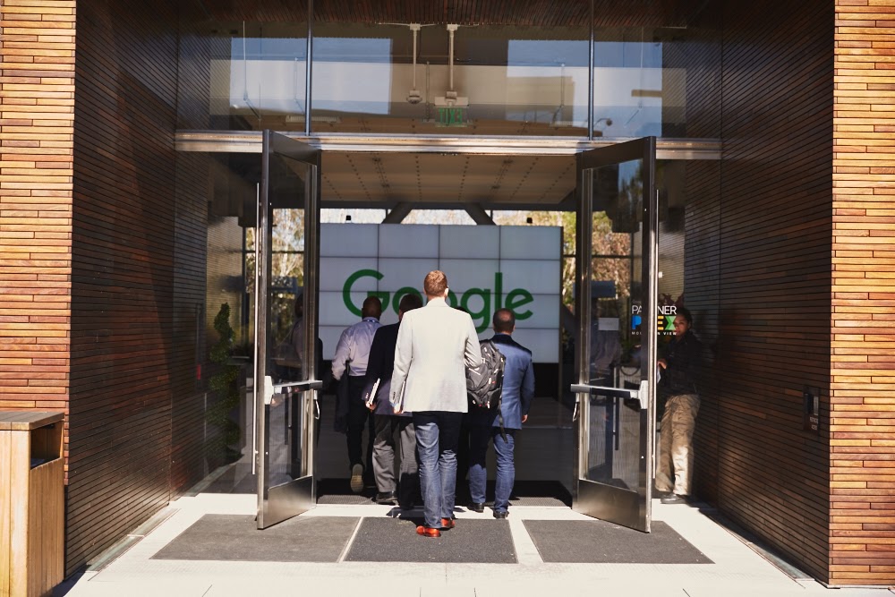 People walking through the Google headquarters entrance.