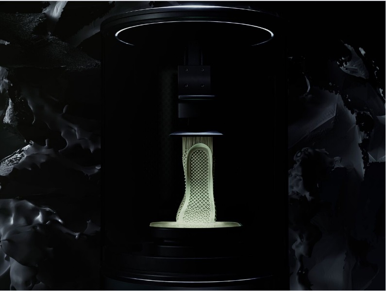 A midsole being 3D printed -- it's rising from a pool of liquid resin.