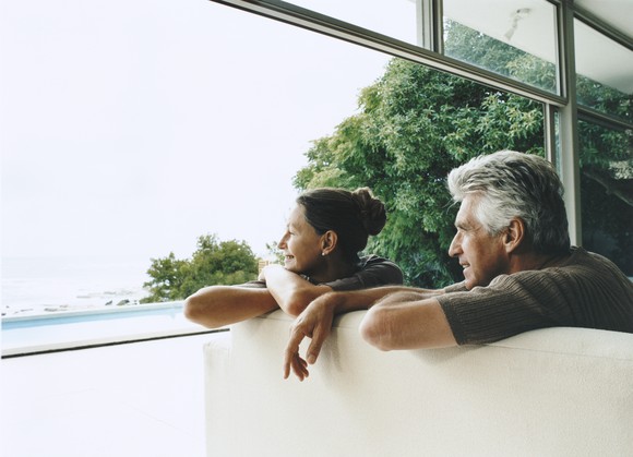 Senior couple looking out the window