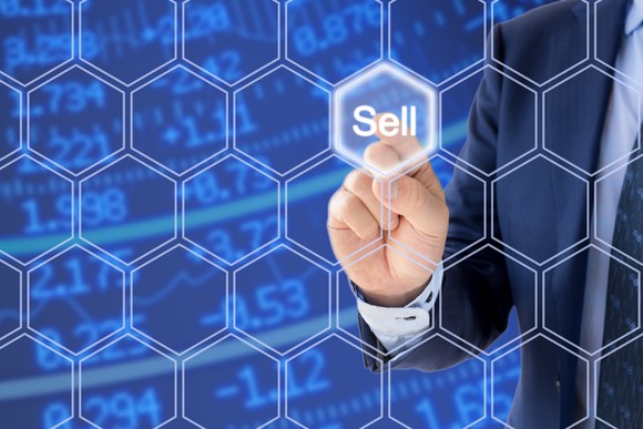 Man pointing to sell button