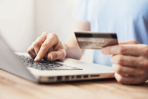 Shopping on a laptop with a credit card.
