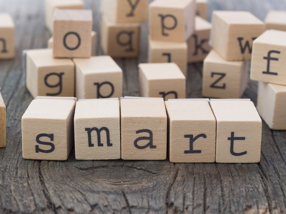 Five wooden blocks, with letters that spell "smart"
