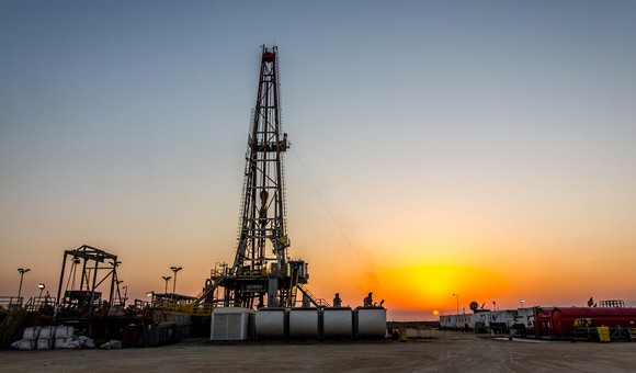 Drilling rig operating at sunset.