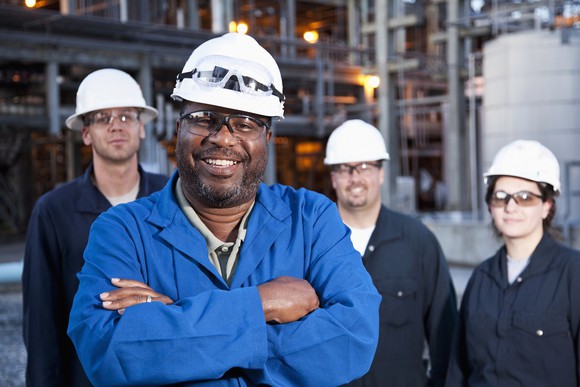 Employees of a petrochemical facility pose for a photo.
