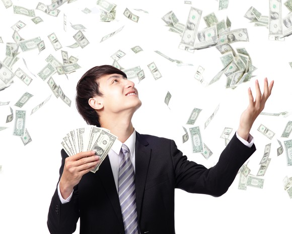 man juggling money in the air