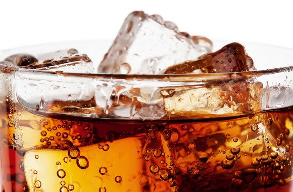 Close-up of a soft drink with ice cubes.