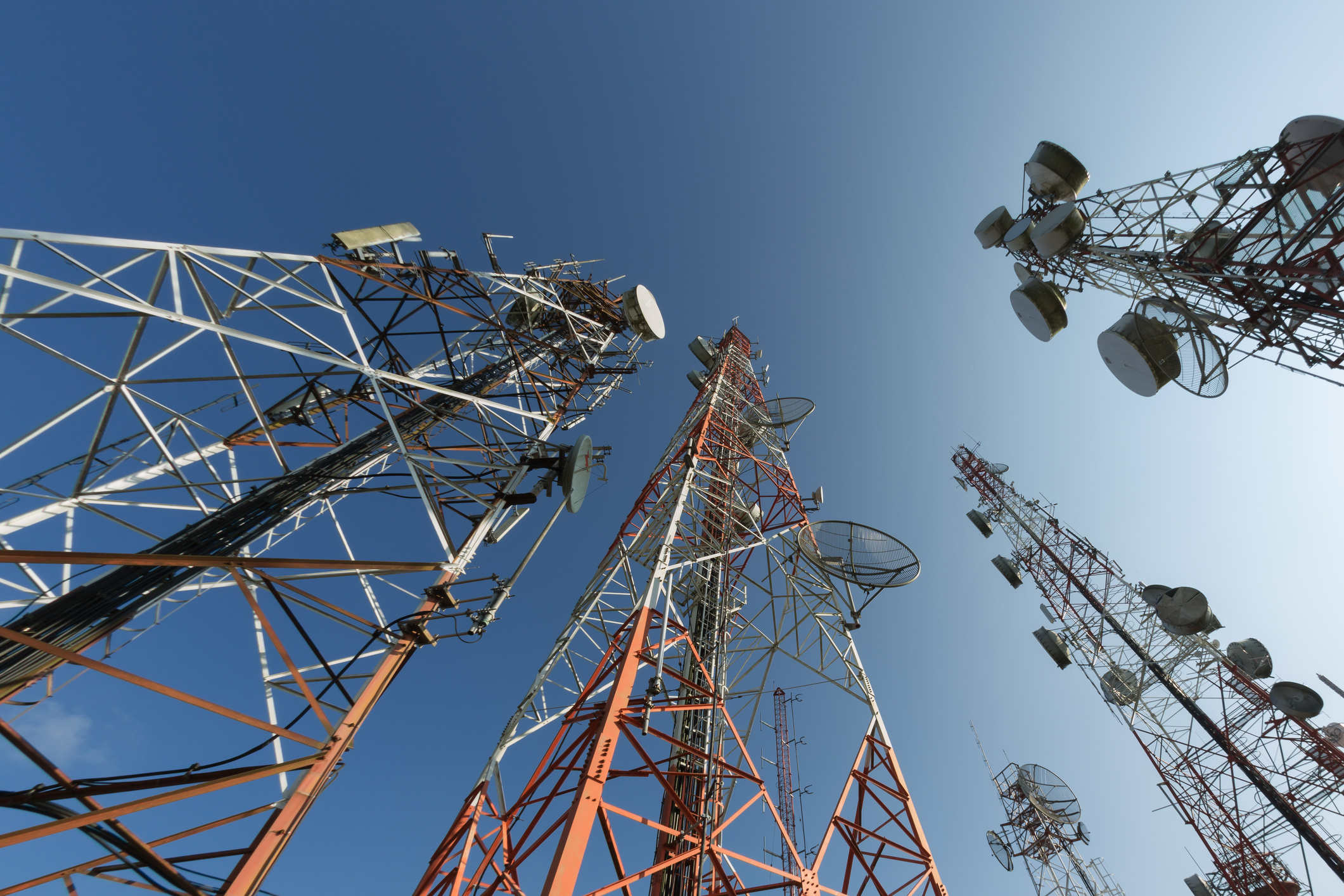 Cellphone and broadcasting towers shot from below.