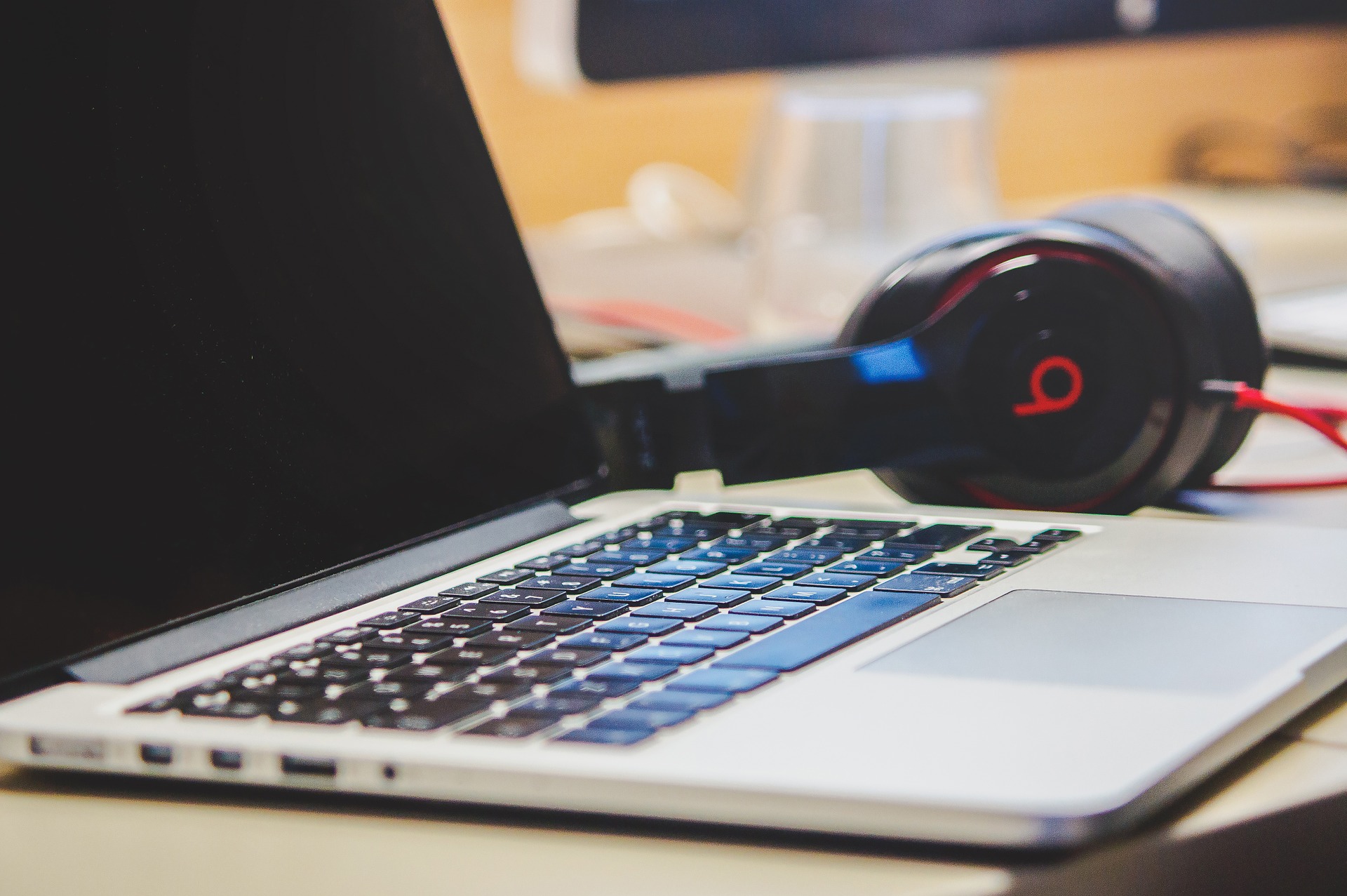 Mac computer with Beats headphones attached.