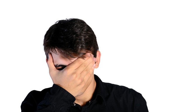 A man with his face in his palm.