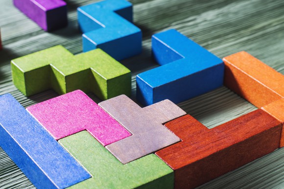 Colored wooden blocks positioned together like a puzzle.