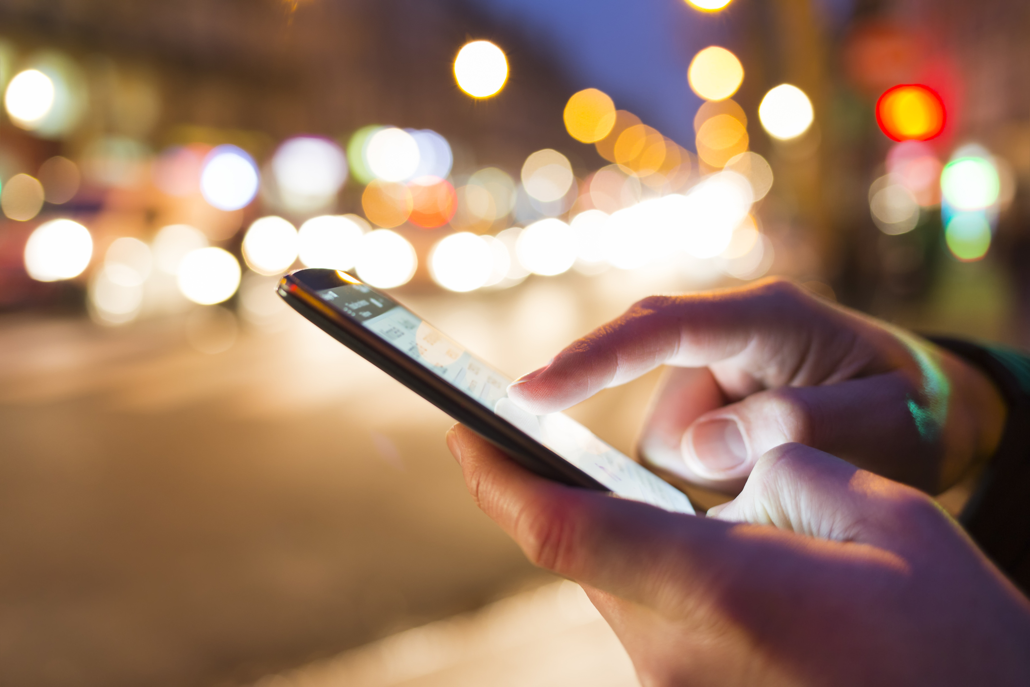 Man using his Mobile Phone in the street.