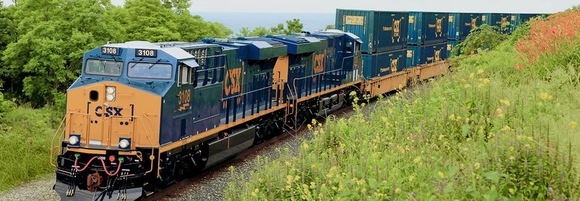 A CSX train in motion through the countryside