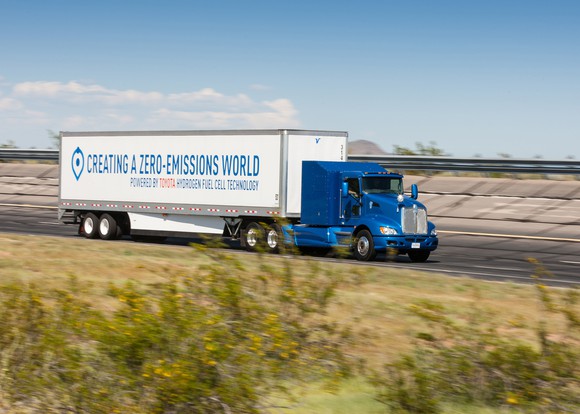 The Toyota tractor-trailer on a country road.