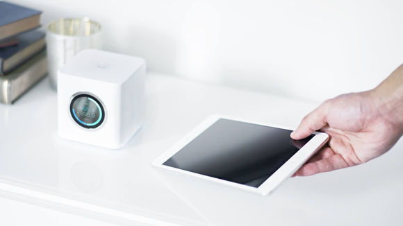 Amplifi router with hand laying down a tablet