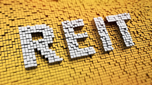 Pixelated acronym REIT made from cubes, mosaic pattern.