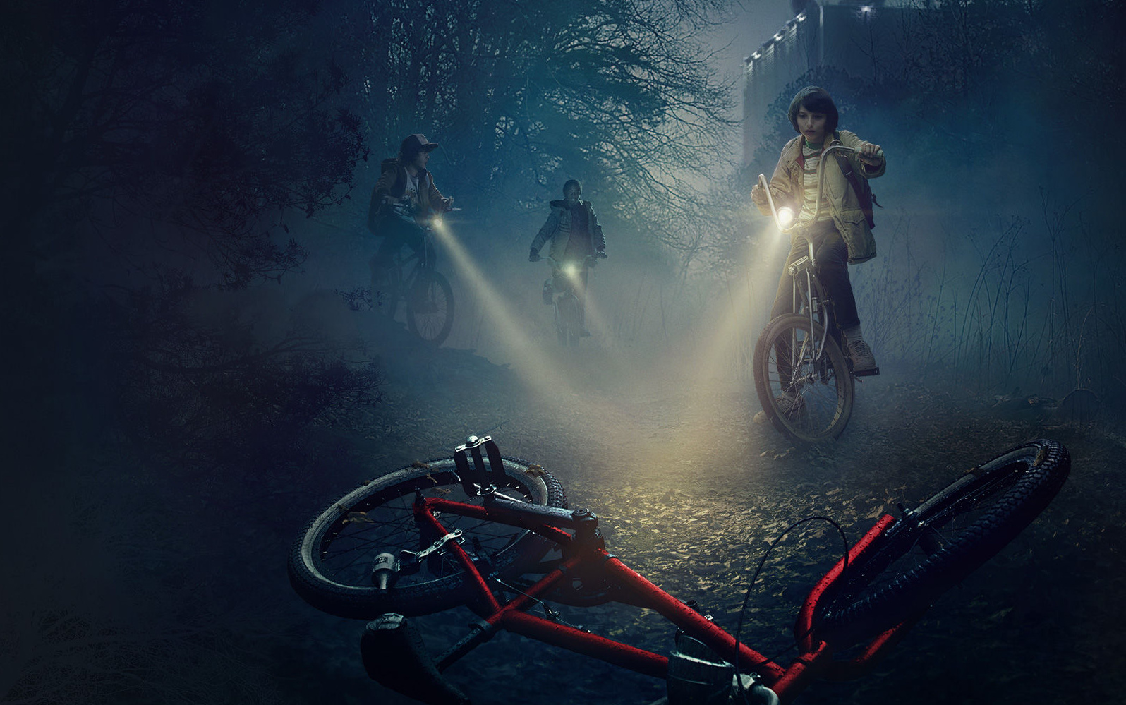 Banner for the show "Stranger Things," with flashlights through the mist