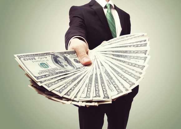 business man holding a fan of money