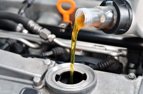 Oil being poured into an engine.