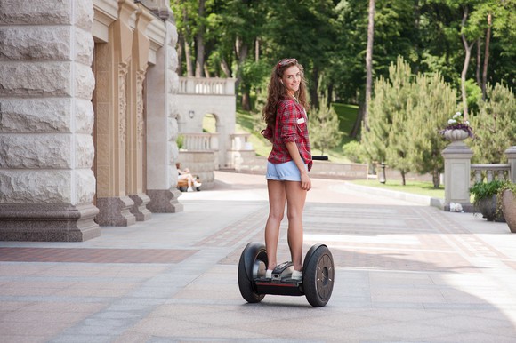 Woman on Segway looking back at camera