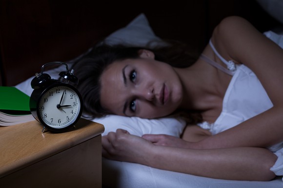 Woman in bed awake at night