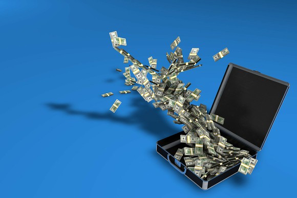 Money flying out of a briefcase.