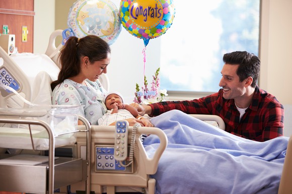 Mom and dad with newborn in a hospital room