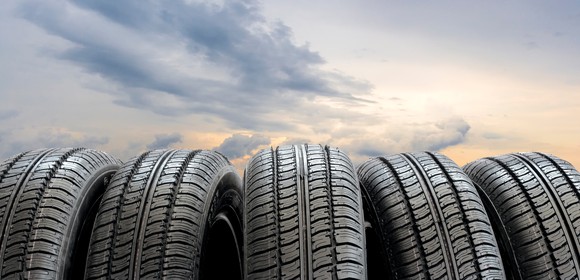 Tires lined up outside at sunset.