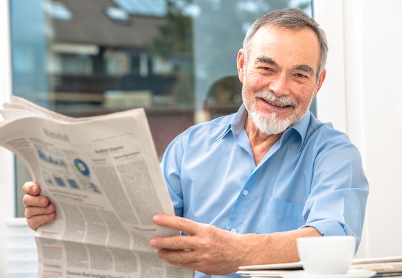 Older man reading a newspaper