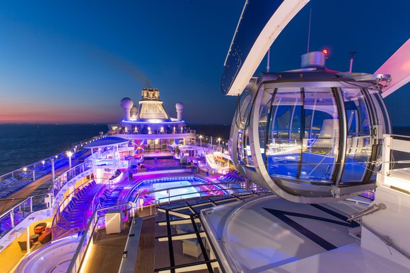 A observatory deck on top of a Royal Caribbean cruise ship lit up at night.
