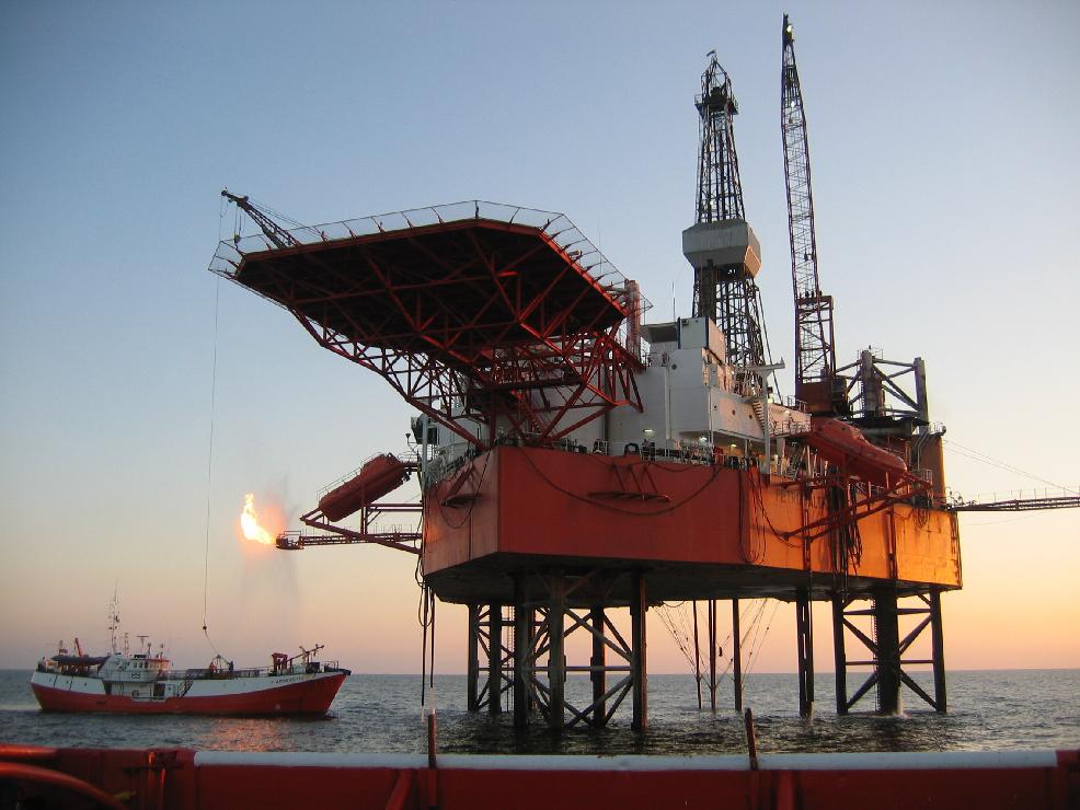 Jack-up rig on site with tender vessel 