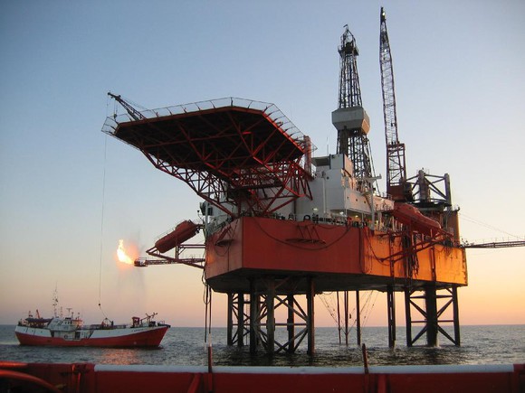 Jack-up rig on site with tender vessel