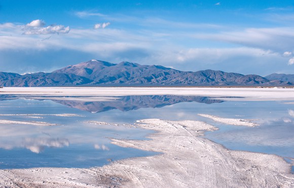 Brine containing lithium in front of a mountain.