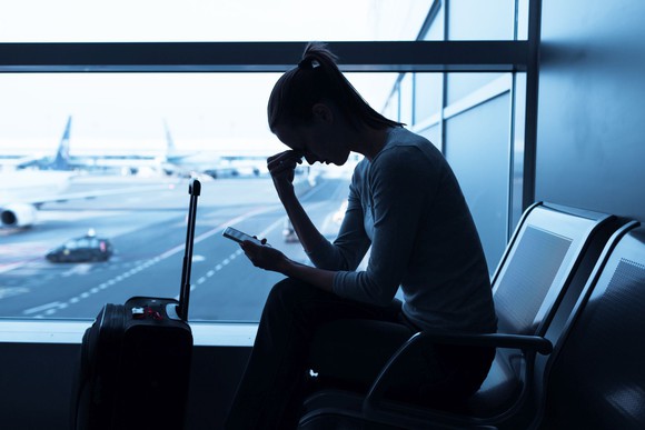 Frustrated woman sitting in airport