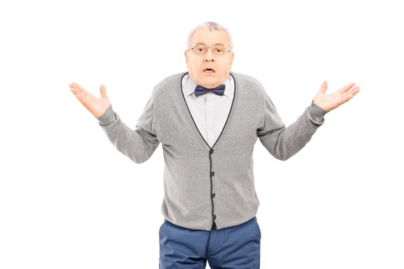 An elderly man shrugging his shoulders