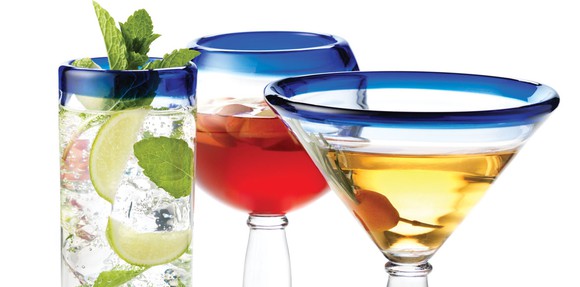 Three glasses, made by Libbey, each with a mixed drink in them.