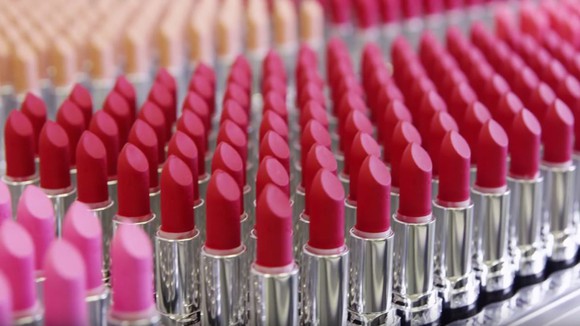 An army of red lipstick tubes in a square formation.