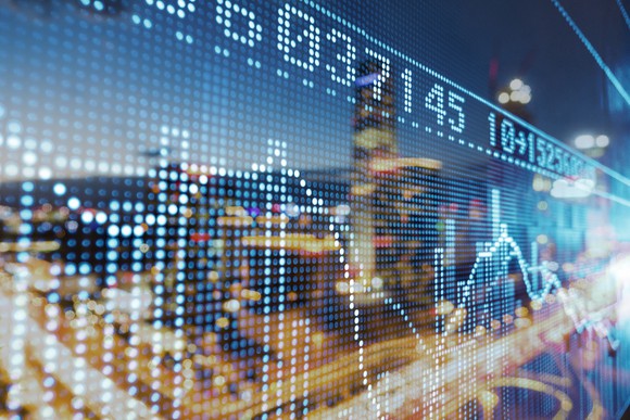 A animation of a stock chart laid over the image of a city scape.