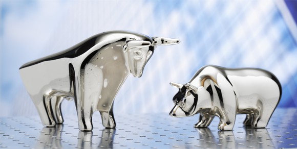 A glass bull and bear on a table.
