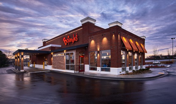 The outside of a Bojangles' restaurant at dusk.