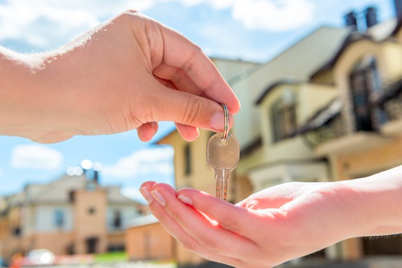 Transferring the key to a buyer.